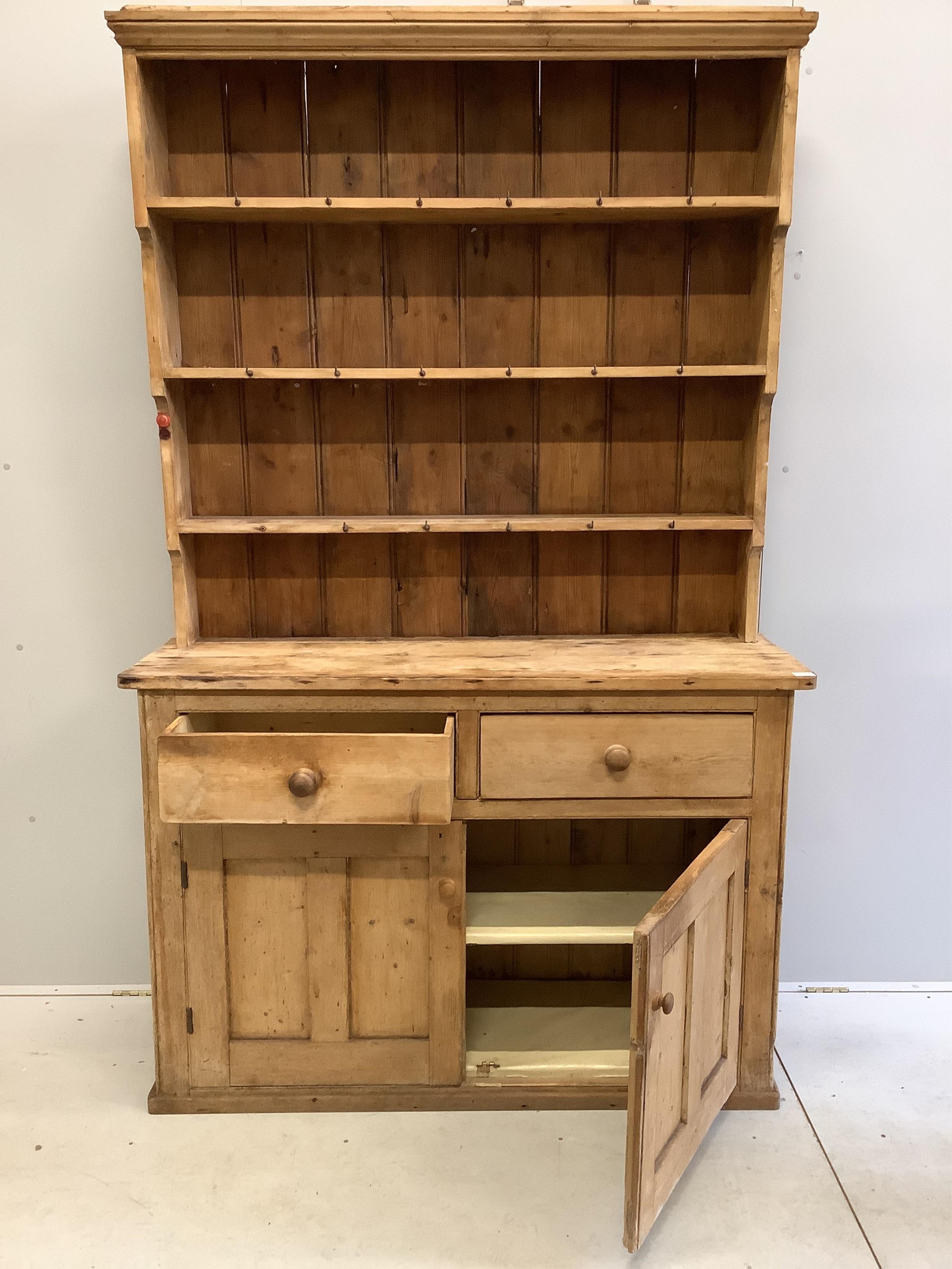 A Victorian pine dresser with boarded rack, width 140cm, depth 46cm, height 122cm. Condition - poor